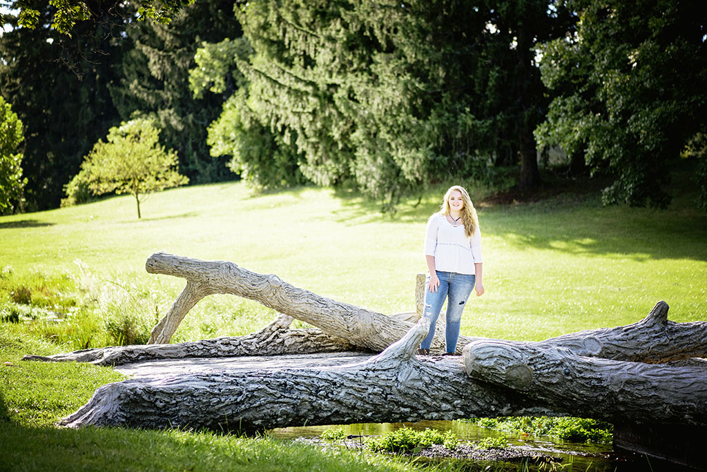 Michigan Senior Portraits - Senior Standing on Bridge in McCourtie Park near Jackson Michigan