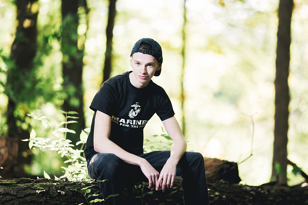 Michigan Senior Portraits - Guy Senior Sitting on a Log